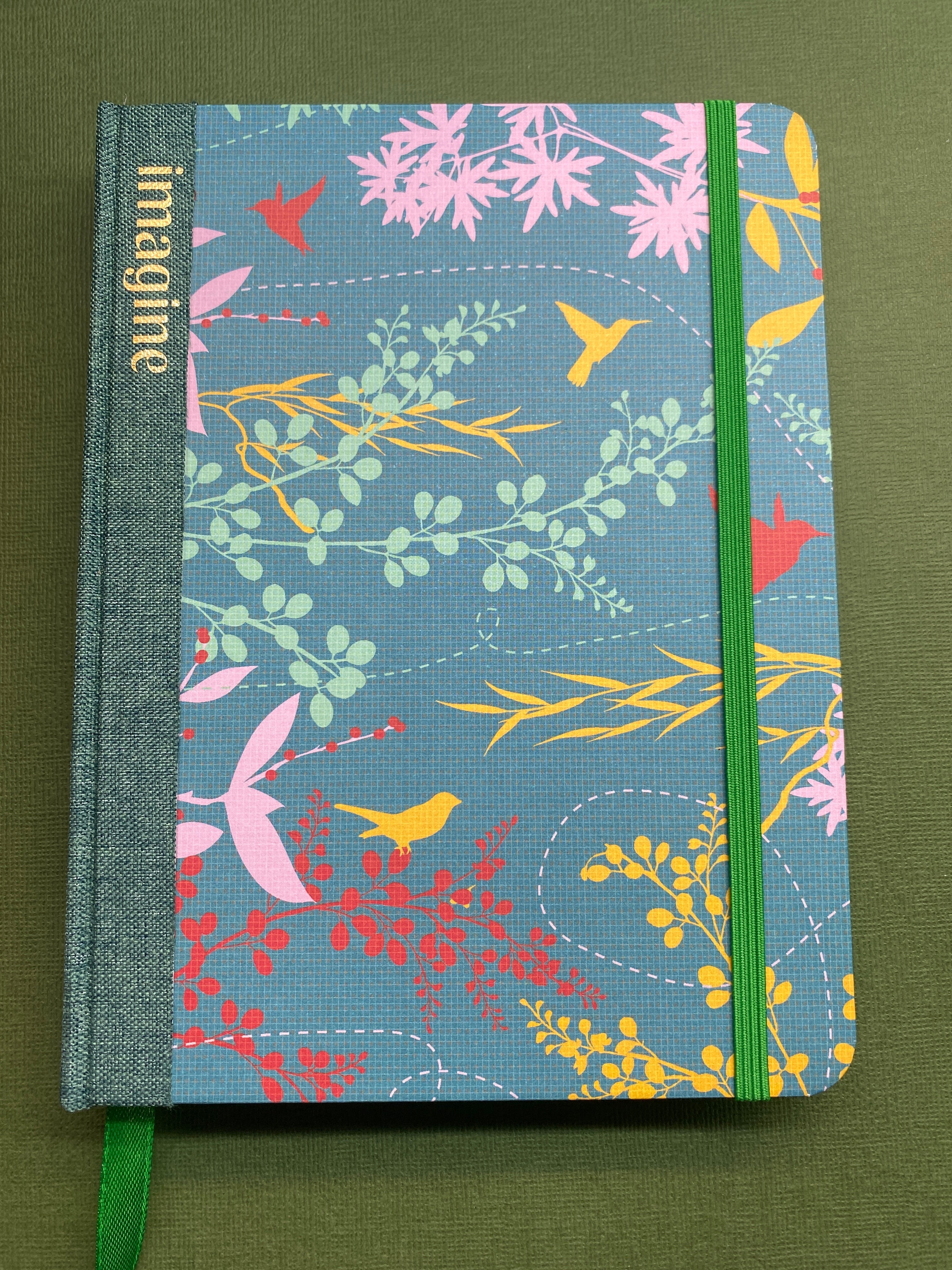 Handmade creative Journal with floral pattern and 'imagine' text on a green background